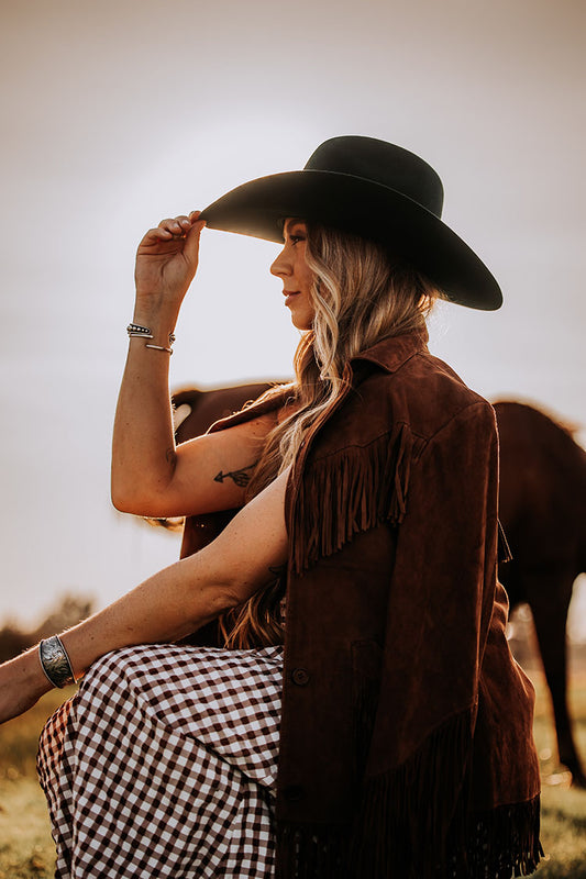 Crafted from 6X fur felt in dark olive, this hat features a 4” wide shovel brim paired with a tall brick crown that measures 4 1/2” tall. The hat is finished with a goat leather sweatband, a polished metal concho set, a silver 7/8 inch ribbon, and a special edition royal blue satin liner.